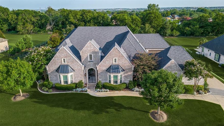 Welcome to this extraordinary single-story pool home nestled in the esteemed, gated Christie Farms neighborhood in Prosper. Enter through a private courtyard that creates a warm welcome for guests and leads to the Casita-style living quarters—perfect for visitors, or in-laws. The home is gracefully situated on an expansive, beautifully landscaped 1-acre lot, offering an impressive 5,200 square feet of refined living space. The flowing floor plan is thoughtfully designed for both grand entertaining and everyday comfort, with five generously sized bedrooms—each featuring its own ensuite bathroom for ultimate privacy. The primary suite stands out with oversized bay windows, while the spa-like en-suite bath features a soaking tub, separate shower, dual closets and dual vanities. The heart of the home is the gourmet kitchen, fitted with top-of-the-line Wolf appliances, custom cabinetry with glass doors, striking granite countertops, & a massive walk-in pantry! The expansive island opens to an inviting family room bathed in natural light. Adjacent to the main living area, you’ll find a combination game room and media room, tucked away for privacy—an ideal setting for entertaining family and friends. A dedicated wine, beverage, icemaker, and wet bar area further enhances the home's hosting capabilities. Additional amenities include hardwood floors throughout, a well-appointed office with a spacious storage closet, and a cabana bath for poolside convenience. Step outside to enjoy the expansive covered patio and outdoor kitchen, which overlook an immense backyard oasis with a sparkling pool—perfect for creating your own private resort ambiance. The property offers ample parking with two spacious garages (28x25 and 25x25). Located in the highly sought-after Prosper ISD, with proximity to Cockrell Elementary, Rogers MS, and Walnut Grove HS. Don’t miss the opportunity to make this remarkable residence your own, in one of Prosper’s most prestigious communities.