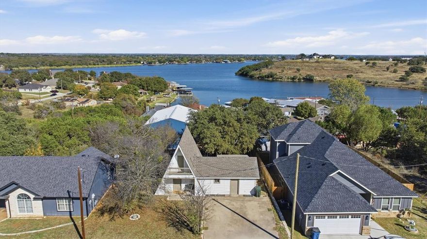 *MOTIVATED SELLER*Your dream lake-house retreat awaits on highly desired Lake Granbury. Welcome to 2707 Austin Dr, a beautifully updated A-frame home tucked inside the secure gated community of Canyon Creek. Filled with warmth, character and natural light, this home blends modern style with the cozy feel of classic lake living.
This charming 2 bedroom, 2 bath floor plan also features an upstairs bonus room that easily functions as a 3rd bedroom, game room or guest suite. The open living space showcases tasteful finishes and soft, inviting colors, creating a peaceful atmosphere from the moment you step inside. The adorable lake-inspired kitchen features an island, stainless steel appliances and everything needed to make hosting effortless — and the refrigerator conveys.
Take in the breathtaking lake views from the private upstairs balcony, sip coffee on the welcoming covered front porch, or bring your boat and toys — the oversized driveway provides plenty of room for parking and storage.
This home has been thoughtfully updated with fresh interior and exterior paint, laminate and tile flooring and modern fixtures, making it move-in ready for full-time living or weekend escapes.
Located in one of Granbury’s most loved gated communities, Canyon Creek offers true resort-style amenities including:
big pool and small pool, basketball court, tennis courts, multiple parks and playgrounds, community fishing dock and boat docks, ramps and clubhouse and 24-7 gated security.
Residents rave about the peaceful setting, wonderful neighbors and relaxed lifestyle.
Whether you're looking for a serene full-time residence, a lock-and-leave weekend getaway or an affordable lake-house investment, this home delivers the Granbury lifestyle so many dream of and rarely find at this price point. Come experience it for yourself and see why everyone loves Granbury.