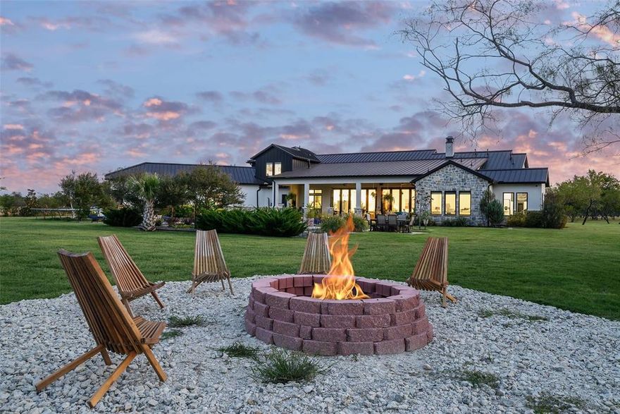 Experience the ultimate in luxury, privacy, and comfort at this stunning gated estate on 6.5 acres in Tacoma Ranch. This thoughtfully designed one-and-a-half-story home offers most living spaces conveniently on the main floor, with folding doors connecting indoor and outdoor areas for a bright, open atmosphere—perfect for entertaining or relaxing in peace.
The chef’s kitchen is a culinary dream, featuring commercial-grade appliances, a built-in refrigerator, a spacious island, and rich natural wood finishes. The open floor plan flows effortlessly through multiple living areas, enhanced by decorative lighting, double vanities, and a state-of-the-art smart home system.
Step outside to your private resort-style oasis, meticulously upgraded by the seller with top-of-the-line pavers, lush landscaping, a pool, spa, and sport court. The outdoor kitchen, complete with BBQ, fireplace, and covered patio, makes entertaining effortless. Quality-built fencing, a tranquil pond with sprinkler system, and expansive grounds create a serene, private environment.
Additional luxury features include a metal roof, electric shades, energy-efficient systems, generator, and a garage with two storage lifts. Every detail of this estate reflects the highest level of craftsmanship and thoughtful investment—perfect for those seeking both grandeur and comfortable, mostly single-level living.