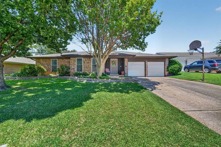 This charming single-story home in the established Meadow Creek neighborhood offers comfort, functionality, and an ideal location close to shopping, dining, schools, parks, and convenient access to I-20. Featuring 3 bedrooms and 2 bathrooms, the home provides a well-designed layout that supports both everyday living and easy entertaining. The spacious living area serves as the central gathering space, highlighted by vaulted ceilings with exposed beams and a brick fireplace with mantel that adds warmth and character. The kitchen is equipped with dark cabinetry, granite countertops, a white tile backsplash, stainless steel appliances, and a dedicated built-in workspace for added versatility, with 90% of the cabinets featuring convenient Pull-Out shelving. A functional laundry area includes additional cabinetry storage. The primary suite offers a comfortable retreat with natural light and a private en-suite bath, while additional bedrooms provide flexibility for guests, family, or office use. Bathrooms feature clean, practical design with well-maintained finishes, including dual vanities and a shower-tub combination. Outdoors, enjoy a well-kept backyard complete with a patio and utility shed, offering space for relaxation, storage, and outdoor enjoyment. The home’s exterior provides welcoming curb appeal within a quiet, established neighborhood setting. Blending timeless charm with everyday functionality, this property presents an excellent opportunity to personalize a well-located South Arlington home. Additional highlights include a heat pump and a full-yard sprinkler system for year-round comfort and convenience.