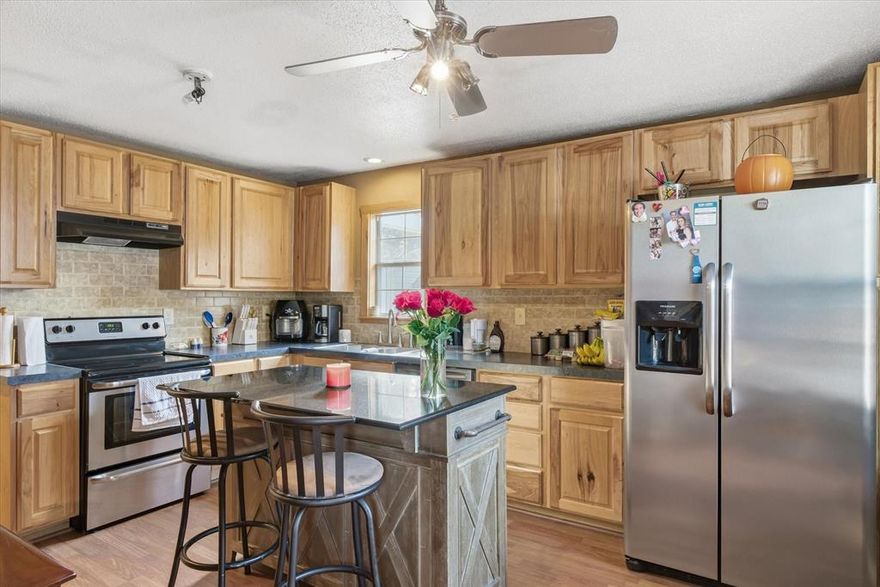 Welcome home to this beautifully maintained 2 bedroom, 1 bathroom home, offering the perfect blend of comfort, character, and convenience. Located in a quiet, serene setting, this move-in-ready property is ideal for first-time buyers, downsizers, or anyone seeking a cozy retreat with modern touches. Step inside to a bright and inviting living area featuring a wood-burning fireplace, perfect for creating a warm and relaxing atmosphere on cool evenings. The updated kitchen is designed for everyday living and entertaining, complete with an island for extra prep space, abundant cabinetry, and stylish finishes. A standout feature of this home is the spacious primary bedroom, highlighted by French doors leading to the front porch, filling the room with natural light and offering effortless indoor-outdoor flow. The large bathroom includes a dual vanity, a beautifully tiled walk-in shower, and convenient access to a generous walk-in closet. Enjoy year-round outdoor living on the covered, screened-in porch, the ideal spot for morning coffee, reading, or unwinding at the end of the day. The property also includes a 3-car carport with attached storage, providing ample room for vehicles, tools, and hobbies. Additional peace of mind comes with the recently replaced HVAC system. This charming home offers comfort, style, and value, all in a peaceful location. Don’t miss your chance to make it yours. Schedule your showing today!