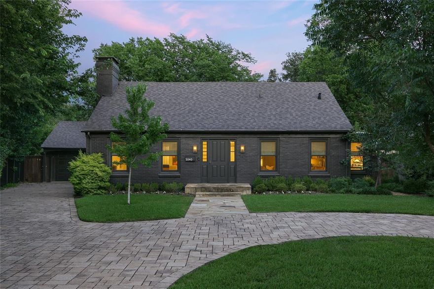 On .337 acres in the coveted Bluffview area, 5040 Horseshoe Trail pairs timeless architecture with elevated, modern design. Renovated in 2021 in collaboration with designer Jennifer Littke of SETSTUDIO, the home features a sophisticated palette of natural materials and bespoke details. The entry is flanked by a library featuring custom walnut millwork and a formal living room with fireplace. The kitchen impresses with custom white oak cabinetry and flows to the breakfast and family rooms, where a wall of windows frames views of the lush backyard. The 1st-floor primary suite offers a spa-like bath with separate tub and shower, custom white oak cabinetry, marble details, and a well-appointed walk-in closet.  The primary suite also features a private porch for morning coffee or evening beverages overlooking the backyard. Additionally, the downstairs offers formal dining, a powder bath, laundry and a 2-car attached garage.  Upstairs, two spacious rooms share a beautifully finished hall bath. The enviable outdoor space is full of mature trees, lush green spaces, a walking path, and a fire pit creating a serene retreat for year-round enjoyment. With three living spaces, impeccable finishes, and walkability to many of Dallas’ most acclaimed restaurants and shops, 5040 Horseshoe Trail sets a new standard of luxury in Bluffview!