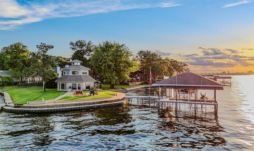 Perched gracefully on the point within the gated haven of Beachwood Estates, this architectural gem unfolds as a lakeside sanctuary where each room frames an ever-changing panorama of serene water views. Step inside to a sweeping great room that flows effortlessly into a kitchen and laundry space adorned with ample cabinetry, generous counters, and fully included appliances—ideal for both casual breakfasts and sunset gatherings. The main-level primary suite, complete with full ensuite with a jetted tub, walk in closet, solarium, and direct lake access, offers a quiet retreat, while upstairs two light-washed secondary bedrooms with roomy closets stand ready for guests or creative setups. A loft, with expansive windows, overlooks the living area, and above lies a crow’s nest—a full height lofty perch perfect for reflection or skyward daydreams. Outdoors, a spacious patio with a cozy fireplace invites lively evenings under the stars. The somewhat recently built boat dock was raised above full pool level to help protect against the occasional storm. The dock is thoughtfully equipped with an automatic boat cover, double jet-ski lift, lake pump, and covered seating area. Add to this a three-car garage—with RV-ready electrical hookups and sewer clean-out—and enjoy the communal perks of a private POA: clubhouse, pool, tennis or pickleball courts, playground, pier, and ramp—all tailored for the leisurely lake lifestyle you’ve been dreaming of.