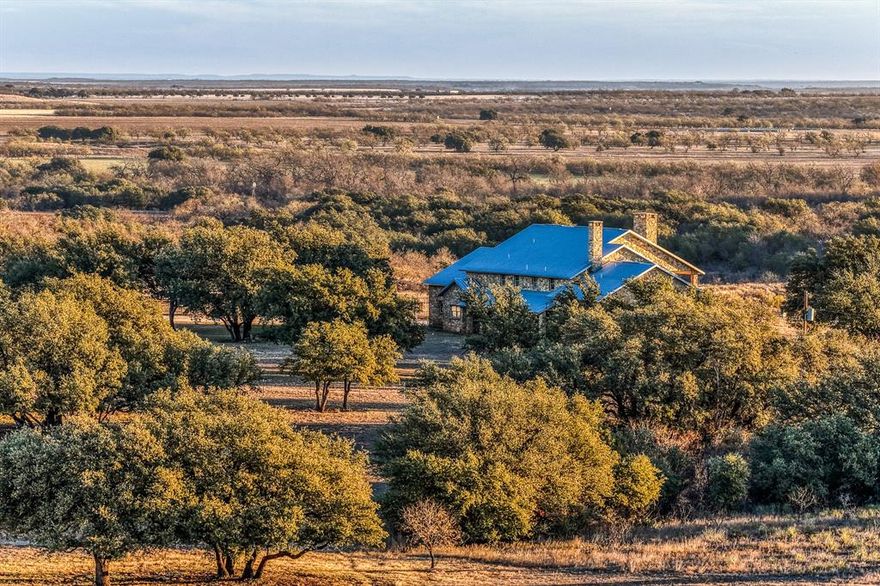 The 392 acre CM Ranch is a turnkey, full scale Texas ranch built for both enjoyment and day to day operation, featuring a premier main home, strong water, quality horse and cattle infrastructure, and a layout that works. With multiple pastures, productive ground, and a large lake setting, this property delivers a rare blend of comfort, function, and long term value in one complete package.
The centerpiece is a two story rock home set high with sweeping views across the ranch and the lake. Built in 2002, the home is approximately 6,000 square feet per owner and features 5 bedrooms and 5.5 bathrooms. The garage enters into an oversized mud room and laundry room, the main living area is anchored by a rock fireplace and expansive windows, and upstairs includes 3 bedrooms, a game room, a media room, and a balcony. The home is supported by three newer air conditioning units.
Horse facilities include a barn with 8 stalls with water and a hay loft, plus a foreman’s suite inside the horse barn with a full kitchen and full bathroom. Water is a standout feature with five tanks total, including a larger tank lake that can be approximately 20 feet deep when full and roughly 8 to 10 acres at capacity. The ranch is divided into 8 pastures and offers excellent wildlife habitat. The owner reports strong deer activity when wheat is up, along with turkey, quail, and other native game, and the property has not been hunted in approximately 15 years.
For cattle and crops, approximately 75 acres have been planted in wheat, canola, and Sudan for hay, and the ranch currently runs about 25 head for casual ranching. Additional improvements include an equipment barn and multiple water taps throughout the property. Utilities include county water, Coleman County Electric, a 250 gallon propane tank for the kitchen stove via West Texas Gas, internet currently via Starlink with county service wired to the house and barn, and a 500 gallon diesel tank on stilts at the barn.