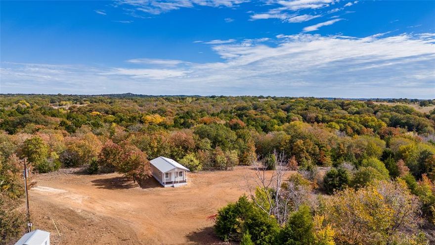 Nestled on a sprawling 10.224-acres this charming 562 sq ft home offers a serene retreat with boundless potential. The property has no deed restrictions, presenting a blank canvas! The cozy one-bedroom, one-bathroom home is a haven of tranquility, ideal for individuals or couples seeking a simpler lifestyle or a weekend getaway. Despite its compact size, the space is efficiently designed to maximize comfort and functionality. Surrounding the home, the vast land offers a peaceful escape with ample room for expansion, gardening, or even raising animals.  Location-wise, you're conveniently situated just 15 minutes from Decatur, 50 minutes from Fort Worth, and 35 minutes from Denton. This proximity allows for easy access to city amenities while still enjoying the peace of rural living. Whether you're looking for a starter home, a project property, or a peaceful retreat, this unique offering blends simplicity, freedom, and a connection to nature, all within reach of city conveniences.