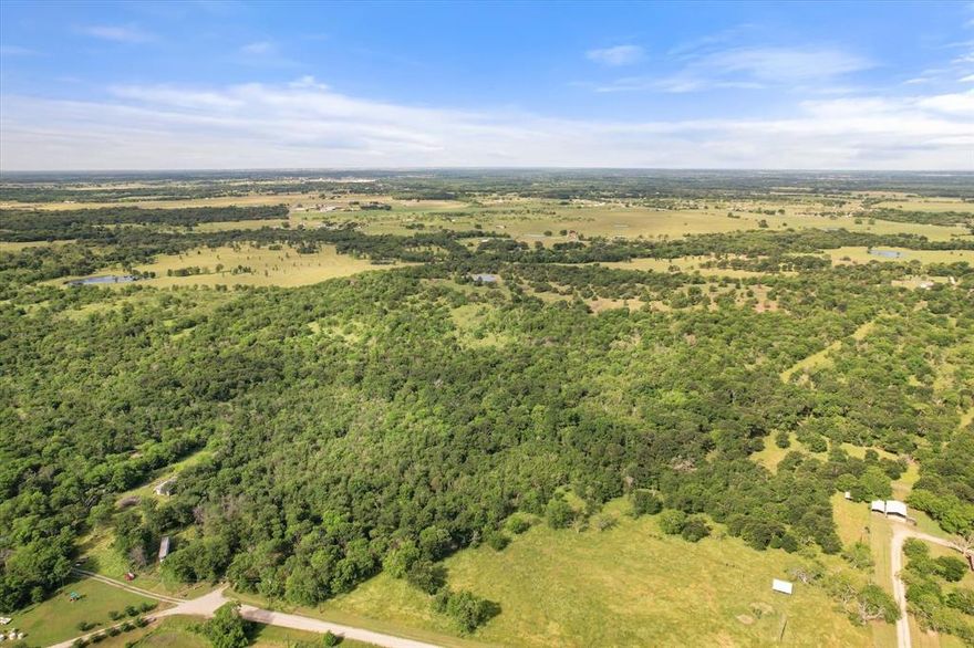 10 Acres in Navarro County with utilities, septic and living quarters!  This tract of land is located outside of the city limits, so you get the benefit of no city taxes while only being 10 minutes from town! 10 acres is big enough for your dream home and all your animals!  The land is heavily treed and full of wildlife. Bring your boots so you can walk the property and see all it has to offer. Barndominuim has kitchen, living space, full bathroom and is perfect for a weekend getaway or a hunting cabin! Call today to schedule your property tour