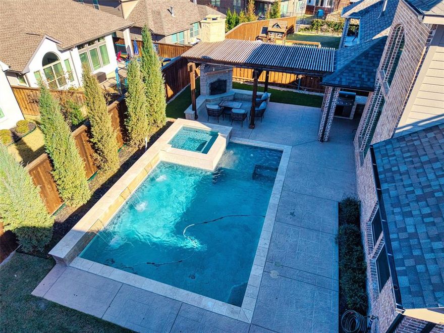 Why start from scratch when you can step right into luxury—and save a fortune doing it?  Welcome to your private oasis in Walsh Ranch, where this pre-existing, beautifully maintained home delivers tens of thousands of dollars in features today’s new builds simply don’t include. Forget spending $120K–$180K (or more) to add a pool, spa, outdoor kitchen, pergola, and fireplace after closing. This home already has it all—a sparkling heated pool and hot tub, a full outdoor kitchen under a covered pergola, and a cozy outdoor fireplace—ready from day one. No construction. No delays. No surprise invoices. Just instant enjoyment and long-term savings. Inside, you’re welcomed by soaring 20-foot ceilings, a bright windows flooding the space with natural light, and a dedicated private study. The open layout features a warm dining area and a breathtaking two-story family room framed by elegant arched windows. The kitchen stands out with incredible storage, extensive cabinetry, and a custom built-in hutch—perfect for everyday living and effortless entertaining.  The extended primary suite is a true retreat, while upstairs offers a spacious game room, three generous bedrooms, a full bath, and a Jack-and-Jill bath—plenty of room for family and guests. Fresh paint, new carpet, and meticulous upkeep make this home truly move-in ready.  Living in Walsh Ranch adds unbeatable value: enjoy a community athletic club, resort-style pools, parks, creative studios, a wood shop, a high-end market, plus front-yard maintenance and blazing-fast 2 GB internet—all included with your HOA.   Why pay more for a new home with less? Get luxury, savings, and instant amenities—without the construction wait. Schedule your showing today and experience the value difference for yourself! Solar panels will be paid off at closing.