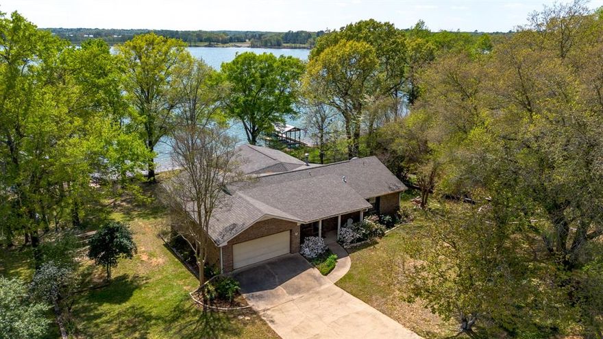 Wake up to panoramic Lake Winnsboro views in this beautifully designed waterfront retreat, where indoor comfort and outdoor living come together effortlessly. The modern kitchen—with updated appliances, a central island, and seamless flow into the open kitchen, living, and dining area—creates the perfect setting for gathering with family and friends. Just beyond, a spacious indoor patio wrapped in massive windows fills the home with natural light and frames the lake like a work of art.

The generous primary suite is its own private escape, offering peaceful water views and direct sightlines to the showstopping two-tiered deck. Step outside and you’ll find one of this property’s biggest advantages: an expansive multi-level outdoor space built for grilling, dining, sunbathing, entertaining, or simply unwinding with the lake as your backdrop. Stairs on both sides lead down to the backyard and waterfront, where your lakeside boat dock invites you to cast a line, enjoy the breeze, and make the most of lakefront living.