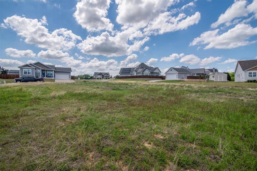 This  corner lot sits within a gated, craftsman style community, and offers the perfect setting to bring your vision to life while maintaining the cohesive charm of the neighborhood. With architectural guidelines in place, each home reflects the timeless character of craftsman design, creating a thoughtfully curated streetscape throughout.
Located just minutes from Lake Texoma and Tanglewood Resort, this property offers the ideal balance of everyday living and weekend escape. Residents enjoy access to a private community pond, perfect for casting a line or simply unwinding by the water.
Situated in the Pottsboro school district, this is an opportunity to build in a location that combines lifestyle, design, and convenience. Whether you’re planning a full time residence or a retreat near the lake, this lot provides a beautiful starting point in one of the area’s most desirable settings. Located outside the city limits.