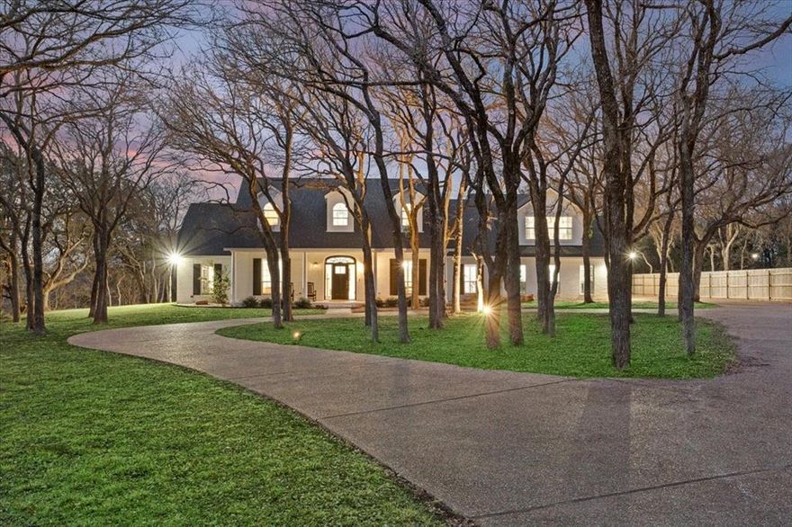 Tucked away on a quiet 1.9-acre cul-de-sac lot in Hidden Valley and surrounded by mature trees and forest, 1061 Hidden Valley Court offers rare privacy with exceptional space and upgrades throughout. Recently remodeled, this home features an open-concept main living area anchored by a chef’s kitchen with a large center island, a six-burner stainless steel range, new cabinetry, and Taj Mahal quartzite countertops. The main level also includes a breakfast space, a formal dining room, and a second formal living area. Additional downstairs highlights include a walk-in pantry with quartzite counters and open shelving, an executive office, an oversized utility room, and a fifth bedroom currently used as a workout room. The isolated primary suite features a spacious walk-in closet, dual vanities, a garden tub, a tiled shower, and private access to the back patio, which is wired for a hot tub. A recent addition above the garage provides a third living area, ideal for recreation or media space, along with an oversized bedroom and full bath with hall access. Upstairs in the original portion of the home are two additional bedrooms, each with its own en suite bathroom, plus an additional living space dedicated to these bedrooms. The backyard is a true retreat, featuring an extended patio, a recently built swimming pool with a tanning ledge, and a guest house with a kitchen, full bath, and living and sleeping areas. Additional amenities include a circular drive, an extended driveway, an expanded three-car garage with workshop potential, a 50-amp 240-v car plug-in in the garage, a propane tank for appliances, updated lighting, and luxury vinyl plank flooring. Located in Midway ISD, this property offers 5+ bedrooms, multiple living areas, 5+ bathrooms, and unmatched privacy in Hidden Valley. Schools: South Bosque, River Valley Middle School, and Midway High School.