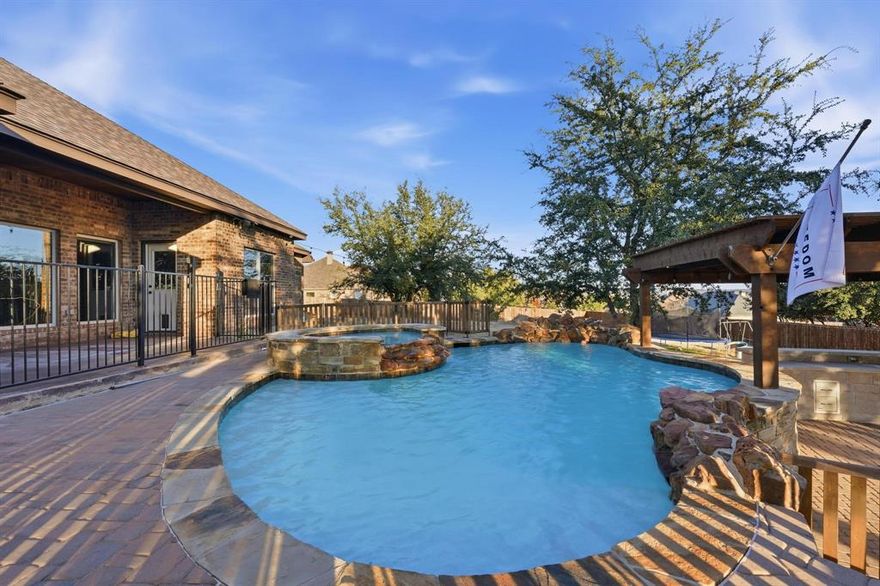 Come experience this highly updated Sandstone home where the views truly are what dreams are made of. From the moment you arrive, the exceptional curb appeal sets the tone, featuring beautifully updated and meticulously maintained landscaping, along with newly added sidewalks spanning the entire front and side of the home. A circular driveway offers both elegance and convenience, complemented by a recently added stained concrete, secondary driveway, providing your guest with ample parking.

Step through the stunning wood and glass front door and into a grand, light filled space showcasing an open layout, vaulted beam ceilings, rich woodwork throughout and a stunning, stoned fireplace. Expansive windows frame breathtaking pool views and rolling hills beyond, creating a serene, mountain like backdrop.

One wing of the home offers three generously sized bedrooms and a well appointed hall bath with dual vanities. The opposite wing is a private primary retreat with peaceful pool views and a spacious spa inspired bathroom suite. The primary bath features separate dual vanities, a large walk in closet, a freestanding soaking tub, and a luxurious walk in shower with dual shower heads.

The outdoor living space is truly an entertainer’s paradise. Designed for the whole family, it includes a children’s playground, outdoor kitchen, pergola, fire pit, and a stunning stone clad heated pool complete with hot tub and resort style Baja shelf. You can't forget the outdoor shower, that completes this exceptional backyard oasis.

This home is surrounded by peaceful, beautiful nature, but just minutes from all your shopping, and entertainment needs. This home definitely offers the best of both worlds. If you are searching for an exceptional property in the highly sought after Jim Ned ISD, this is the one!