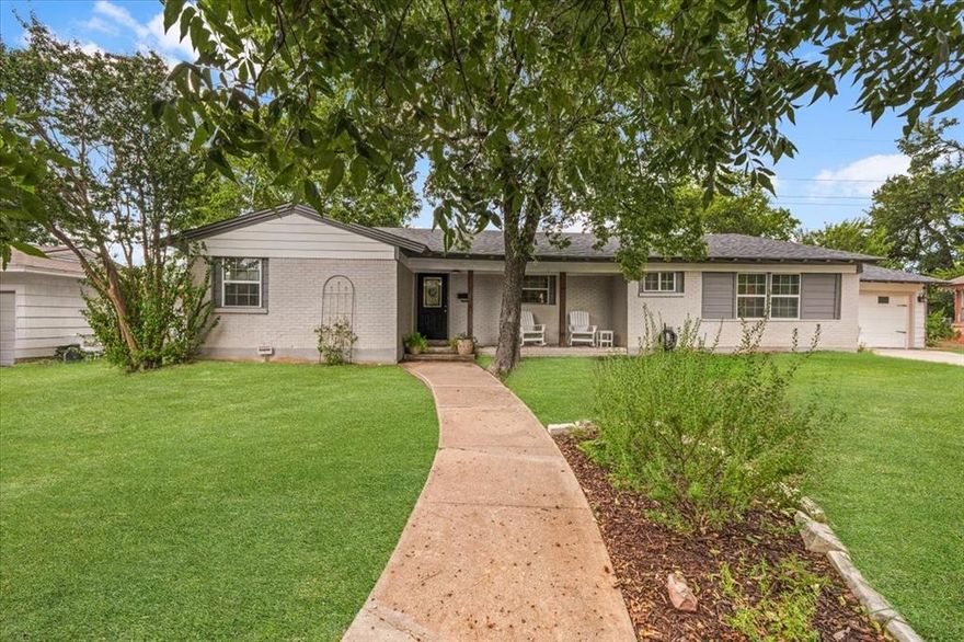 Welcome Home to this charming, fully remodeled ranch style home in the heart of Richland Hills! A brand-new roof, fresh interior and exterior paint, and luxury vinyl plank flooring carry through the entire home for a clean, cohesive look. The welcoming, rocking-chair front porch opens to an airy living and dining space filled with natural light and easy flow to the backyard. The bright kitchen features white shaker cabinetry, subway tile, granite counters, stainless appliances, and a warm wood island—perfect for meal prep and casual gathering! Bedrooms are comfortable and spacious, with an updated bath showcasing a long granite vanity and beadboard detail. Outside, the oversized yard delivers that country living feel—a covered patio, mature trees, room to roam, play, or garden—plus a long driveway and two-car garage! Tucked in a quiet neighborhood just a short stroll to nearby schools and with quick access to the highway, this move-in-ready home blends peaceful living with everyday convenience. Schedule your showing today!