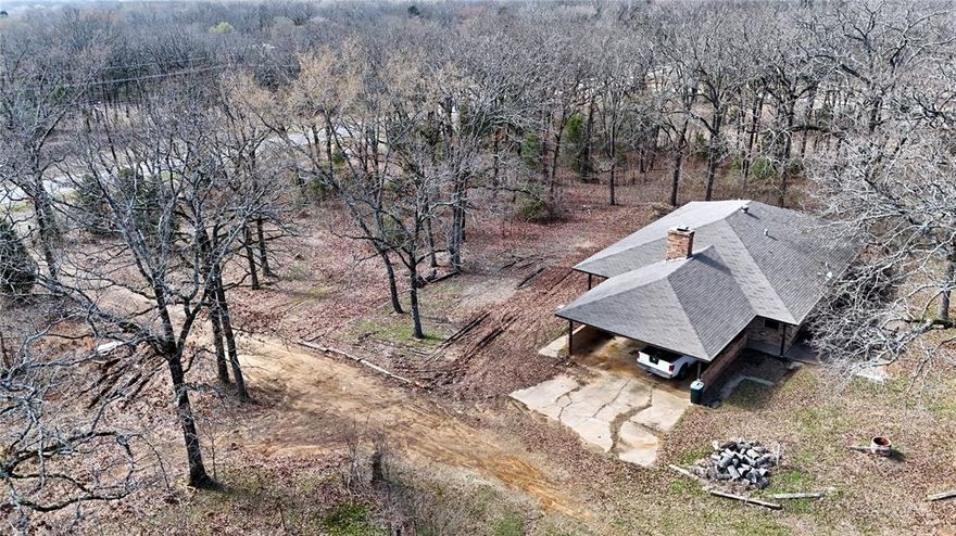 Located in Henderson County, Texas, this prime 10-acre property is nestled between two established developments, The Bluffs and Cedar Creek Ranch. The land offers a balanced combination of open pasture and wooded areas, creating a versatile mix of usable ranch land and natural wildlife habitat.  The brick ranch-style home features 3 bedrooms, 1.5 bathrooms, attached two-car carport. Additional improvements include a barn, storage shed, a pond. The property is serviced by deep Wilcox water. Enjoy peaceful country living with room to spread out, all while being HALF A MILE from Cedar Creek Lake. NO RESTRICTIONS, this property provides flexibility for a variety of uses. Opportunities like this are becoming harder to find — don’t miss this rare offering.