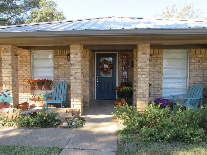 Welcome to this unique 4 bedroom, 3 bath home that is ready for you to enjoy. Seller has really done a lot of beautiful renovations including Hickory Hardwoods in the kitchen and living area. A new bedroom with an on-suite has a large, tiled walk-in shower. Also included is a spacious living area with laminate flooring that opens to the back yard. The other two guest bedrooms use the hall bathroom with a tiled tub shower combination. These bedrooms also have new carpet and two closets. The Primary Bedroom has an on-suite with walk-in Tiled shower and a vanity with marble counter. The floor is tiled and there is open storage for towels. The kitchen with breakfast area is a cook's paradise. Seller has installed a beautiful counter with stainless steel top and lots of cabinets for storage in the breakfast area. The kitchen counters are marble and stainless steel. Kitchen includes a gas cook top, built-in oven, broiler, trash compactor, a new Media dishwasher, a divided stainless steel sink with new garbage disposal. Above the breakfast table are new modern light fixtures. Breakfast area also looks out to the back yard thru a 3 part bay window. Kitchen also includes a pantry. The laundry room is off of the kitchen behind a lovely door with glass insert. The spacious den has a vaulted, beamed ceiling. Very cozy with the large fireplace with heavy wooden mantel. Fireplace is either wood burning or gas logs. All rooms have ceiling fan light combos. Most fans are Hunter 60 fans. One other room is the office dedicated to the owner's trophies. He is very talented and has trophies to honor his endevors.  The 2 car garage has 2 automatic openers and storage with shelves attached. The steel 22 gauge roof is approximately 3 years old, AC units are newer. The backyard is ideal for entertaining under the large Live Oak tree. A storage building work shop is also included. There is nothing to do but bring your suitcase and move in. Seller just reduced to $285,000!