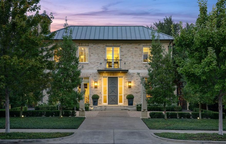 Designed by Paul Turney and built by Kienast Custom Homes in 2019, this three-bedroom, four-and-a-half-bath residence blends classic architecture with modern ease. Tumbled Old English brick, custom metal canopies, and mature trees lend a refined presence along one of University Park’s most distinguished boulevards. Inside, white-oak floors, designer fixtures, and Holly Hunt drapery set a tone of subtle luxury. Natural light fills the open living and dining areas, each framed by woven grass shades and thoughtful proportions. The kitchen combines form and function with Miele and Viking appliances, a Liebherr refrigerator and freezer, and a walk-in pantry designed for effortless entertaining. The primary suite adds heated floors, dual baths, a coffee bar, and automated shades that filter light throughout the day, while guest suites echo the same sense of refinement. The downstairs family den features a built-in sink, refrigerator, and fine stone countertops for everyday living and entertaining. An upstairs media room offers a quiet retreat. A courtyard by Archiverde anchors the home, with cut limestone and artificial turf beneath Savannah Hollies and Japanese Maples. A copper-spouted water feature and an outdoor shower add a resort-like ease. Modern systems enhance every detail: whole-home AV, smart thermostats, motorized window treatments, and an elevator connecting all levels. Located minutes from Highland Park Village and Southern Methodist University, with Armstrong Elementary serving the neighborhood, 2816 McFarlin offers a timeless balance of comfort and craftsmanship.