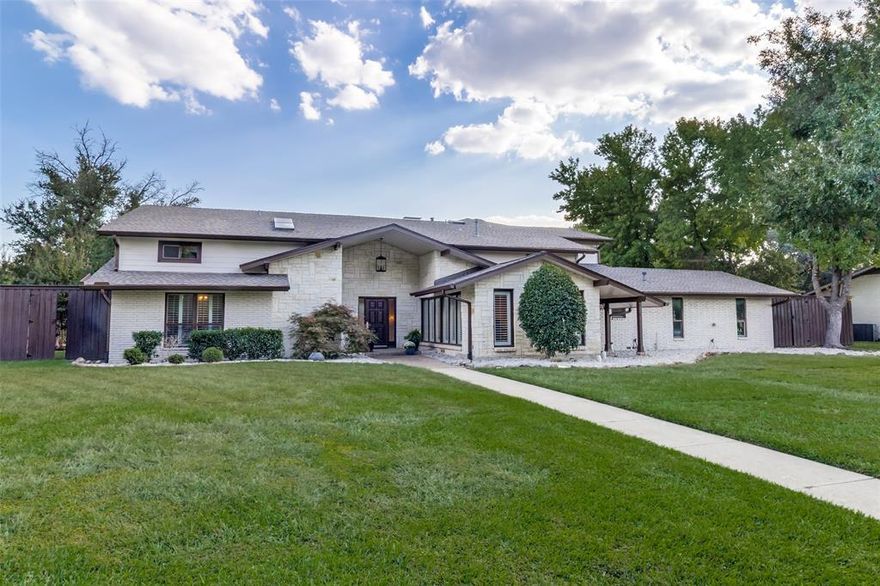 Welcome to this nicely updated family home in the heart of Northwood Hills, situated on a generous 0.40-acre lot.  Many updates have been made in the last 2 years including roof updates (2022), HVAC replaced (2018-2019), hot water heater replaced (2024), cast iron plumbing removed from under the home, french drains added to front yard for extra drainage (2025), new wood floors on first floor and entire first floor was repainted (2025).  Designed for comfortable family living and effortless entertaining, the spacious and flexible floor plan features a primary suite and two bedrooms on the main level, with 3 or 4 additional bedrooms upstairs. Multiple living areas on both floors offer versatile spaces—perfect for a guest suites, home offices, playroom, or media room. Originally renovated in 2008, the home has seen additional updates that enhance both style and function. Interior highlights include solid core doors, wood and travertine flooring, plantation shutters, custom kitchen cabinetry with built-in refrigerator, stainless steel appliances, including a 6-burner gas range, and California Closets system in the primary suite. Step outside to a private backyard featuring a sports court ideal for basketball or pickleball enthusiasts—perfect for active families or entertaining guests.  Located in the highly regarded Richardson ISD and a few minutes from Parish and other private schools. This home is just minutes from top-rated dining, shopping, and amenities.