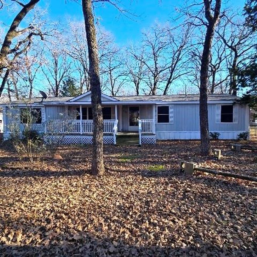 SPACIOUS MFG HOME DOUBLEWIDE THAT IS LOCATED ON 3 LOTS (APPROX 0.5 ACRE) IN QUIET NEIGHBORHOOD. CLOSE TO SHOPPING, MEDICAL, AND ELEMENTARY SCHOOL IN GUN BARREL CITY. THIS HOME OFFERS 3 BEDROOMS, 2 BATHS, 2 LIVING AREAS, OPEN LIVING, DINING AND KITCHEN AREA. PRIMARY BEDROOM AND BATH ARE LOCATED OFF OF THE LIVING AREA NO. 1 ANDOFFERS SEPARATE SHOWER AND GARDEN TUB. PRIMARY BEDROOM CLOSET IS BIG WALK IN. BEDROOM 2 AND 3 HAVE WALK IN CLOSETS. BEDROOM 2 AND 3 AND THE SECOND BATH ARE LOCATED OFF OF LIVING AREA NUMBER 2 WHICH OFFERS WBFP. KITCHEN AND DINING AREA OFFER LOTS OF CABINETS. INTERIOR HOME HAS BEEN FRESHLY PAINTED. HOME OFFERS COVERED PORCHES ON FRONT AND BACK OF HOME FOR ENJOYING OUTDOOR ACTVITIES. STORAGE BUILDING AND FENCED BACKYARD WITH LOTS OF TREES. PROPERTY HAS 2 DRIVEWAYS AND SITS ON BIG CORNER.  A LITTLE COSMETIC WORK NEEDED. COME MAKE THIS YOUR NEW HOME!