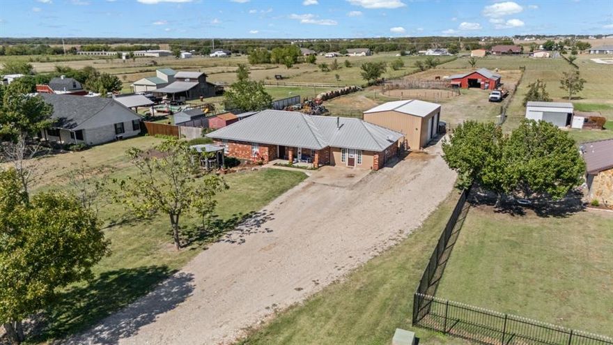 Escape the ordinary and embrace country living at its finest on this beautifully maintained hobby farm on just over two acres—perfect for homesteaders seeking space, self-sufficiency, and rural charm. The kitchen features open shelving, a NEW RANGE, and abundant counter space—ideal for canning, baking, or preparing farm-fresh meals. The convenient floor plan offers two large living areas, providing flexible options for homeschooling, home offices, or multi-generational living. The home includes 3 spacious bedrooms, with the primary suite offering a private ensuite bathroom. Recent updates include a NEW Hot Water Heater, HVAC replaced in 2018, 50-year metal roof added in 2017, and an aerobic septic system installed in 2021. This property is a homesteader’s dream, featuring tons of storage space, cross fencing for easy pasture rotation, and thoughtfully designed outbuildings for both work and play. The impressive 36x24 WORKSHOP, completed in Spring 2024, boasts three 10-ft roll-up doors, 12-ft side walls, 16-ft peak height, LED lighting, and 24-inch beams strong enough to support a car lift. The HORSE BARN is well-built with a 10-ft center aisle, multiple stalls, and a spacious tack room. The loft and hay storage area is capable of holding up to 300 bales of hay. A 30 AMP RV hookup adds convenience for guests or additional living options. This versatile property currently functions as a successful farm with livestock but offers endless possibilities for hobby farming, gardening, and sustainable living—all within a peaceful country setting. NEW HVAC