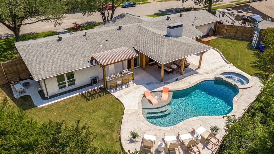 Stunning Corner Lot with an outdoor Oasis with POOL & SPA, KITCHEN, and LOUNGE AREA.
Discover a harmonious blend of luxury and comfort in this stunning 4 bedroom home situated on a generous corner lot. Boasting an inviting private backyard retreat, this home promises both relaxation and entertainment with a heated spa and a sparkling pool, seamlessly controlled from a smartphone app. Recently resurfaced with radiant blue pebble tech and complemented by new tile. The pool sets the scene for an unparalleled leisure experience. The heated spa, complete with a captivating waterfall feature added in 2022, offers an idyllic spot for relaxation. Outdoors, the extensive kitchen and living area provide the ideal backdrop for entertaining. Featuring extended pool decking, this space transforms every gathering into a memorable occasion. Indoors, a modern kitchen awaits, recently renovated to include chic white cabinetry, elegant light countertops, stainless steel appliances, and a stylish subway tile backsplash. The functional island not only houses a convenient drawer microwave but also offers island seating. The grandeur extends into the family room, where natural light pours through expansive windows, offering panoramic views of the backyard oasis. Warm up by the cozy fireplace or create additional living or dining areas to suit your lifestyle needs. Uniformly beautiful flooring flows throughout, including into the bedrooms. The primary suite is a retreat unto itself, featuring an en suite bathroom with dual closets and access to a serene outdoor living space via sliding glass doors. The additional three bedrooms provide versatility, perfect for a home office or workout room. With an epoxy-floored two-car garage providing access to the backyard. Perfect proximity to Highway 635 and the Dallas North Tollway, this home is ideally located near jogging and biking trails and a scenic park.
Seize the opportunity to own this extraordinary residence.