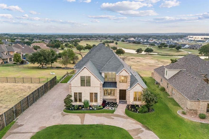 Experience true luxury in this fully remodeled property, perfectly situated in the only 24-7 gated and guarded golf course community on Eagle Mountain Lake. Perched on nearly half an acre, this home captures some of the most stunning golf course and lake views in the neighborhood.
Inside, every detail has been thoughtfully designed. The open-concept floor plan is highlighted by new hardwood white oak floors, designer lighting, and timeless finishes throughout. The chef’s kitchen is a masterpiece—featuring quartz countertops, a marble backsplash, premium appliances making it the heart of the home for both everyday living and entertaining. The first floor offers multiple living and dining areas with stunning views of the golf course and lake from every angle, and an oversized primary suite with a spa-like en suite bath is truly a retreat, combining sophistication with comfort. Upstairs, three additional bedrooms, two full baths, a versatile flex space, and a media room provide plenty of room for family and guests. Blending elegance with functionality, this home offers 4 bedrooms, 3.5 bathrooms, a media room, office, flex space, and multiple living areas. As part of this exclusive community, you’ll enjoy resort-style amenities including an 18-hole golf course, clubhouse with restaurant and bar, two pools, fitness center, basketball and pickleball courts, beachfront area, boat ramp, and private docks. This home is the perfect blend of luxury, lifestyle, and location—a rare opportunity not to be missed