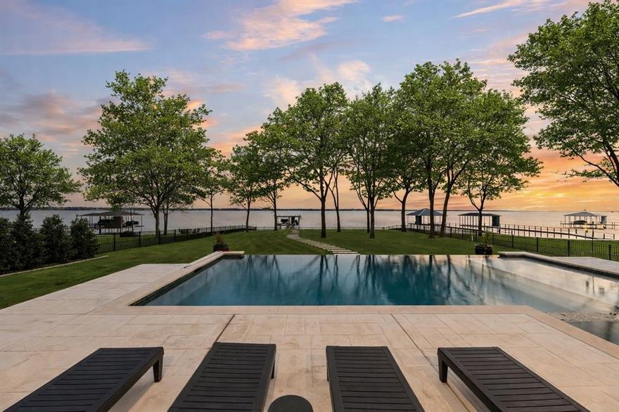 Completed in 2024, this exceptional waterfront residence in The Shores on Richland Chambers Lake offers a refined blend of thoughtful design, modern efficiency, and resort-style living. With 4 bedrooms, 4.5 bathrooms, and a spacious 3-car garage, the home is foam-insulated throughout for energy efficiency and comfort. Luxury designer finishes are showcased in every space, from European solid oak flooring—laid in an elegant herringbone pattern in the foyer and theater room—to custom solid wood cabinetry, crystal door hardware, and premium quartzite and quartz countertops.

Designed for both everyday living and elevated entertaining, the chef’s kitchen features commercial-grade appliances including four ovens, a six-burner gas range with griddle, speed oven, built-in microwave, and a coffee bar. A gas fireplace anchors the main living area, while an electric fireplace creates a relaxing retreat in the primary suite. The theater room includes a custom wet bar with a 24k gold-inlaid sink, icemaker, and beverage refrigerator. Smart-home upgrades control lighting, mirrors, HVAC, pool equipment, garage doors, window treatments, and security, all accessible by phone or remote.

Outdoors, the professionally landscaped grounds feature golf-course-quality Zeon Zoysia sod, a full sprinkler system irrigated from the lake, ornamental aluminum fencing, and a natural stone paver path leading to the boathouse. Enjoy the heated-optional infinity-edge pool designed for lake level viewing, hot tub, and a fully equipped boathouse with boat and jet ski lifts, heat-resistant TREX decking, safety railings, and multiple water access points. A custom spider misting system services both the home and boathouse, ensuring pest control year-round. Every detail—from Italian and Brazilian stonework to whole-house water filtration, tankless water heaters, central vacuum and custom closets—reflects a home built for luxury lake living without compromise.