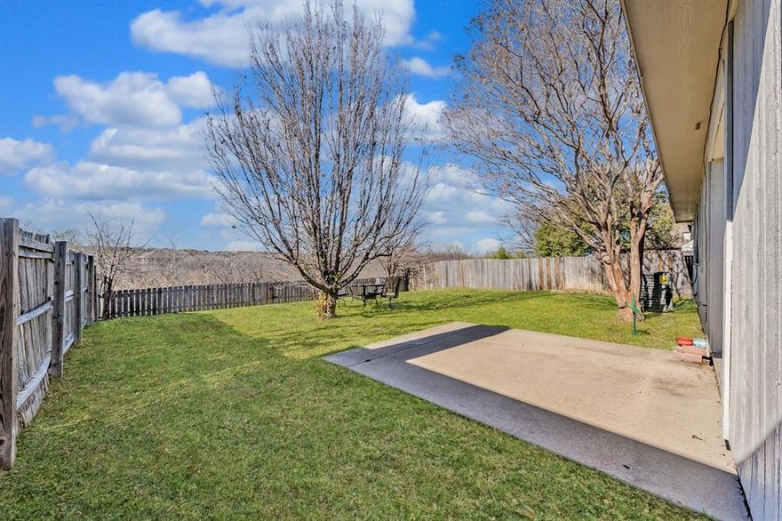 MOTIVATED SELLER!!! Welcome to 6501 Riverwater Trail, a beautifully crafted brick residence nestled in the heart of Marine Creek Hills, where comfort, privacy, and lifestyle blend seamlessly. A stunning mature tree enhances the front of the home, and a welcoming front entry offers a natural sense of separation and flow, creating privacy and an elegant first impression the moment you step inside. This 3-bedroom, 2-bath home offers a flowing, open layout ideal for both everyday living and entertaining. Throughout the main living areas vinyl flooring designed to resemble natural wood provides the warmth and timeless look of hardwood while delivering the durability, easy maintenance. The inviting living area is anchored by a charming wood-burning fireplace. The kitchen is filled with natural light from a beautiful bay window & features generous cabinetry, a pantry, and ample space designed for both hosting & daily enjoyment. Every room in the home is equipped with a ceiling fan, offering year-round comfort, enhanced airflow, and energy-efficient living. The primary suite serves as a serene retreat, complete with walk-in closets & elegant double doors that open directly to the backyard, creating a seamless indoor-outdoor connection. Additional bedrooms are spacious and also include walk-in closets, offering comfort, flexibility, and ease. Step outside to an expansive, private backyard with no neighbors behind, providing a peaceful setting ideal for outdoor living, entertaining, or quiet relaxation. A private patio completes the outdoor experience. Additional highlights include a spacious two-car garage with excellent storage, NO HOA, and a prime location with convenient access to parks, scenic trails, shopping, dining, and major highways. For added value, the washer, dryer, and refrigerator are negotiable with a strong offer. This home delivers space, privacy, charm, and lifestyle in one of Fort Worth’s most inviting communities.