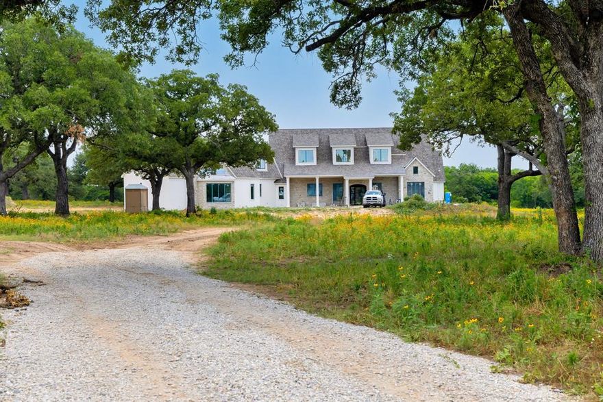 Beautiful property located on perfect place to have your dream ranch. The custom-built home has everything you could ever desire. As you drive up the winding drive to this picturesque country setting and see the magnificent home you be immediately charmed. Upon entering the home, the view of the main living area with tall, vaulted ceilings and beams will stir up excitement to see the remainder of the home. The open concept of living, kitchen and dining offer opportunities to share time with family, and large group gatherings. Kitchen: oversized island, beautiful cabinets, Butler's pantry off kitchen with cabinets, open shelving, built-in China cabinet, and much more. Dining area has coffered ceilings, large utility that is full of cabinets and tons of storage, separate pantry that any chef would envy and much more! Upstairs: large living area, media room, full bath and bedroom and a small kitchen making for convenient entertaining upstairs. Amazing pool and outdoor kitchen too!