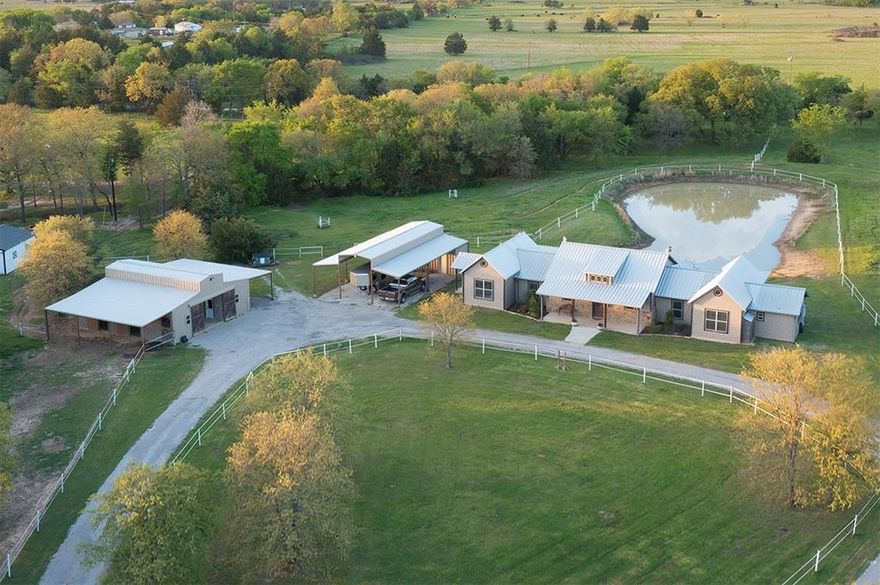 What happens when 8.85 acres of rolling North Texas pastureland meets thoughtful custom design?

This Horseman's Ranch estate answers that question beautifully. From your back patio, you'll overlook four fenced pastures and a stocked pond—the kind of view that makes morning coffee feel like a luxury. The property isn't just scenic; it's purposefully built for the equestrian lifestyle, though its appeal extends well beyond horse owners.

The home itself balances elegance with everyday function. The open kitchen features custom cabinetry, a large island, and premium appliances. The living room makes an impression with cork flooring, vaulted ceilings showcasing cedar beams, and a stone gas fireplace that anchors the space.

The floor plan separates private from public spaces thoughtfully. The east wing houses the primary suite—a genuine retreat with a spa-inspired bathroom featuring a copper soaking tub, walk-in shower, and generous closet. This wing also includes a tucked-away home office, laundry room, and half bath. 

The west wing provides two additional bedrooms, a full bath, walk-in pantry, and mudroom.

Outside, the equestrian infrastructure is exceptional. The 4-stall barn includes a climate-controlled tack room. A 32×40' carport connects to a 32×10' shop, providing covered storage and workshop space. Practical additions include RV hookup, in-ground storm shelter, and 22KW generator.

Horseman's Ranch community amenities include a 130×250' covered riding arena and scenic horse trails.

This property represents country living without compromise—acreage that's actually usable, custom features that enhance daily life, and equestrian facilities that serious horse people will appreciate.