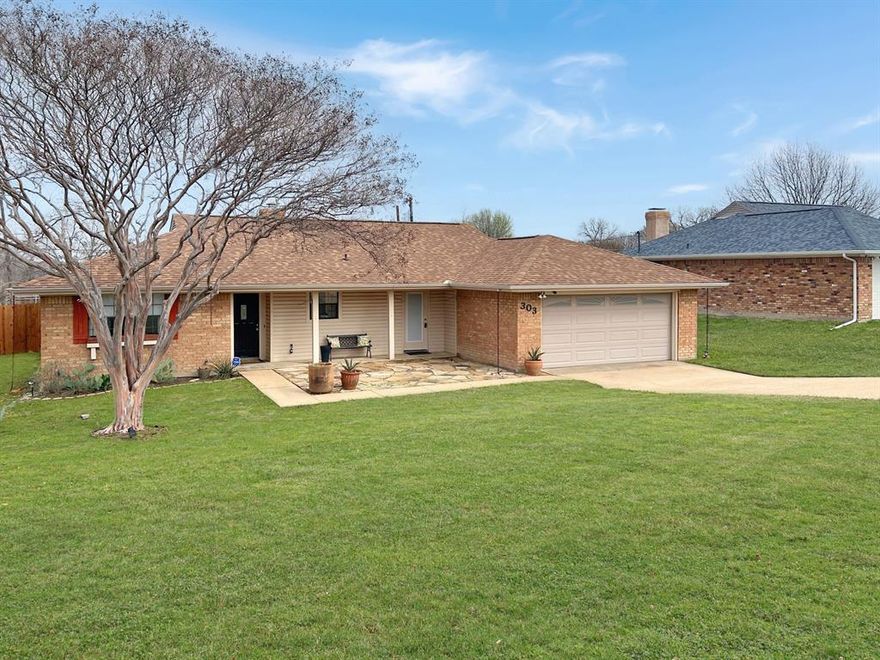 This delightful one-story home has been thoroughly updated and is ready for immediate occupancy. It's located in the heart of Prosper, within walking distance to Downtown Prosper, where major community events take place and various restaurants, coffee shops, and retail shops can be found. At the front of the .28-acre property sits a flagstone courtyard, perfect for entertaining guests or unwinding and watching the sunset.

Inside, the open floor plan showcases all recent upgrades: engineered wood flooring runs throughout most of the home, with tile reserved for bathrooms and wet areas. The kitchen boasts brand-new cabinetry, stainless steel appliances—including a refrigerator-freezer—natural stone countertops, and modern light fixtures. The living room is anchored by a cozy brick fireplace and filled with natural light streaming in from the backyard.

The primary suite features barn doors leading to the ensuite bathroom, which includes a spacious walk-in shower with rain shower heads, double sinks, and a large walk-in closet. The updated laundry room, conveniently located off the kitchen and primary bedroom, offers a utility sink, drip-dry area, and built-in cabinetry. The split-bedroom layout provides two additional bedrooms and a fully renovated bathroom; one secondary bedroom was converted into an office, but the seller is open to converting it back if needed.

Additional features include voice & remote-controlled light switches, a recently installed 6’ privacy fence, and a new HVAC system added in December 2024. The two-car garage contains a workbench and plenty of cabinet and storage space. Situated in the renowned Prosper ISD and near the Gates of Prosper, you'll have easy access to many shopping and dining options.