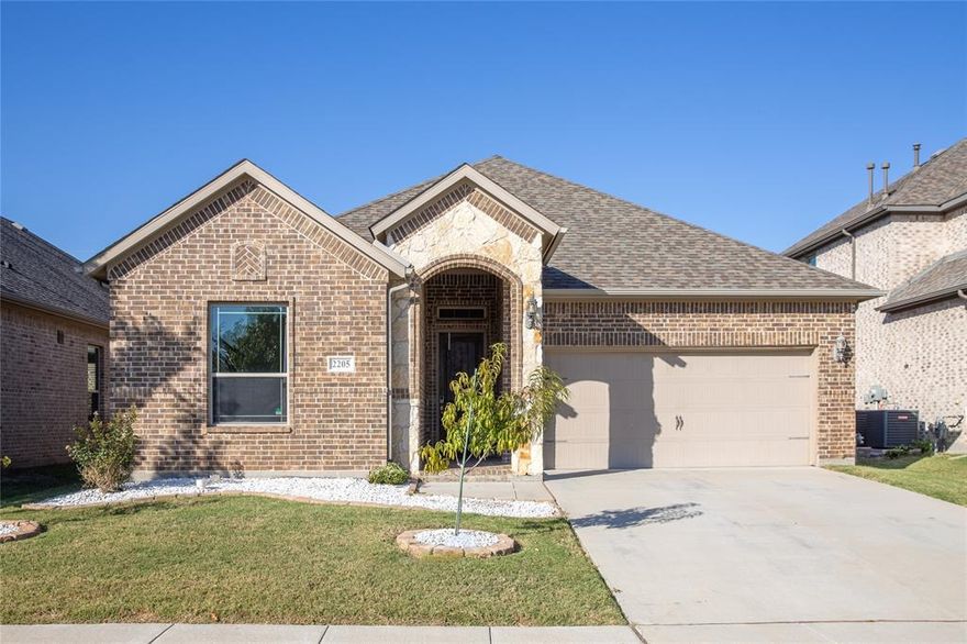 Ready for immediate move in! 12+ month lease, longer preferred. Welcome home to 2205 Granger Lane — a standout residence built in 2017 in the heart of Rowlett’s coveted 75088 ZIP. With 3 bedrooms, 2 baths and approximately 2,100sqft of thoughtfully-laid-out living space, this home seamlessly blends sophisticated finishes with everyday comfort. From the moment you arrive you’ll appreciate the curb appeal, secure setting and flexible floor plan that sets this home apart. Step into a huge family room anchored by a stone fireplace and framed by a wall of windows that bring in abundant natural light and overlook the backyard retreat. The adjacent kitchen is beautifully appointed with a large island, granite countertops, built-in stainless appliances including double ovens, and a wood vent hood — ideal for the chef in the family. Architectural details such as 8-foot interior doors, 5-inch base molding and 6-inch wide hardwood plank floors throughout elevate the home’s interior ambiance.
The private master suite is designed as a true sanctuary: dual vanities, a garden tub, a separate shower and a spacious walk-in closet provide comfort and convenience. Outside, the fantastic backyard features a covered patio — a perfect space for al-fresco dining, entertaining or simply relaxing outdoors in the privacy of your own lot. Whether you’re hosting a casual gathering or enjoying a quiet evening, this home delivers both ease and elegance.