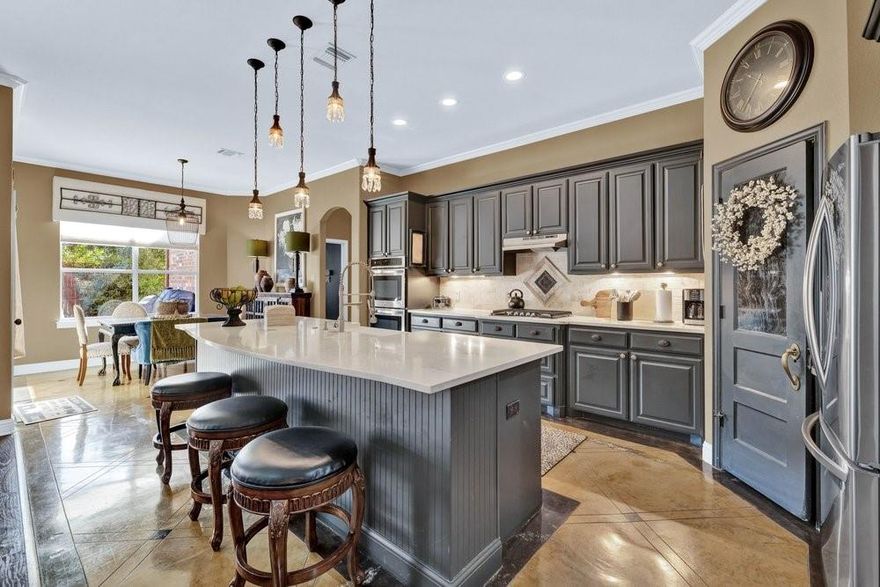 Talk about a show stopper! The elevated kitchen is the star of the show, featuring oversized quartz island with farm house sink, abundant cabinetry, double ovens and gas cooking making this the perfect hub for all your gatherings. Don't miss the retractable charging station in the island! You'll notice the thoughtful floor plan and custom features throughout house. The split bedroom arrangement provides plenty of privacy for the primary suite. The main living space is anchored by a handsome gas fireplace, flanked by knotty alder builtins. The large secondary living space is completely enclosed, with a door and can easily be transformed into a 4th bedroom or an enviable work from home office space. The three car garage is perfect for all your vehicles, toys or even a work shop. End your evenings around the gas powered, stone fire pit while gazing at the Texas sky. If you've been searching for the perfect one story in NRH, don't miss this one!