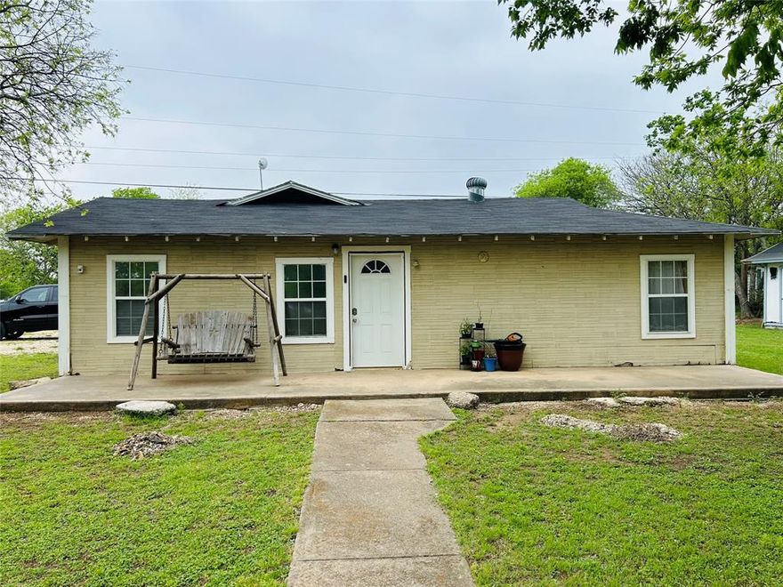 Endless possibilities with this one! Head on out to Lake Whitney and check out this property that has guest home or could be an income producing rental. It is great for an Airbnb, or a full time rental or you could even rent both places out for short term rentals. However, it is set up now for mother in-law quarters. Whichever way you decide you will love the home as it boasts a large living room and eat in kitchen which has a ton of cabinet and counter space.All appliances will convey.It is situated on a large corner lot and walking distance from the lake.There is a large garage set up for a workshop as well and a a half bath out there. New roof has been put on. So if you are looking for a weekend get-away, rental property, or a great full time residence then you will not want to miss out on this!!