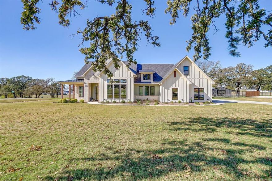 Welcome to the highly sought after Bluebonnet Ridge!  You will appreciate the layout, finish-out and pride in construction shown in this home! Don't miss the brand new 40x60 shop out back with two garage doors and two man doors. Inside the home, you will discover 12' ceilings, abundant natural light, beams in ceiling and elevated design choices. The elaborate kitchen includes a custom range hood, cooktop, double ovens, and microwave built into the 10' island, a beverage cooler and bar area, an oversize window with farmhouse sink, floating shelves and designer lighting. The upstairs bonus room can be used as a bedroom with a full bathroom and closet included. An office off of the entry space is framed by a side wrap around porch with great views. The master bathroom includes his and her vanities, massive closet, freestanding tub and frameless shower glass door. Check out the 12' Andersen sliding door to the oversize screened in porch. This property offers a sense of escape, while being only 4 miles to the highway!