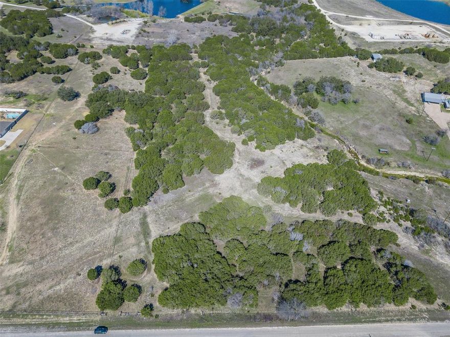 10.2 Acres of Tranquil Texas Land Near Granbury – Endless Possibilities Await!

Discover your slice of country paradise just minutes from the historic Granbury Town Square, Lake Granbury, and Glen Rose! This beautiful 10.2-acre property offers the perfect blend of peace, privacy, and potential. With a portion already cleared and a charming small creek meandering through the land, it's an ideal canvas to build your dream home or create a weekend getaway.

The property is made up of two separate 5.1-acre parcels, each with its own Parcel ID, giving you flexibility to sell one, build multiple homes, or keep the entire acreage for yourself. There are no known restrictions, so bring your vision—whether it's a custom estate, barndominium, or investment opportunity.

Tucked away in a quiet, relaxing setting, yet conveniently close to all the amenities Granbury has to offer, this land is a rare find with tons of potential. Come check it out and start imagining the possibilities!