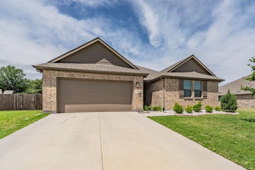 Beautifully maintained home in CITY OF HASLET. Built by ASHTON WOODS BUILDER. This single-story home located in the highly sought-after NORTH WEST ISD school district. The private primary suite is thoughtfully separated from the secondary bedrooms, offering a quiet retreat at the back of the home. An additional secondary bedroom on the opposite side features its own private bathroom, ideal for guests or multi-generational living.
Two more bedrooms are situated on the right side of the home, connected by a shared full bath, with a versatile playroom or game room in between—perfect for entertaining or family time.
The kitchen is a standout with solid surface countertops, an abundance of cabinetry, ceramic tile backsplash, and upgraded finishes, including Moen fixtures and modern lighting and screen doors.  The home also features energy-efficient stainless steel appliances, a Ring doorbell, and 10-foot ceilings throughout.
Step outside to enjoy a fully fenced backyard complete with a sprinkler system, gutters, and a covered patio—perfect for relaxing or hosting gatherings.
The primary suite offers dual vanities, a ceramic tile walk-in shower with glass enclosure, and spacious walk-in closets. With four bedrooms plus a flexible space ideal for a home office, this home offers both comfort and functionality.