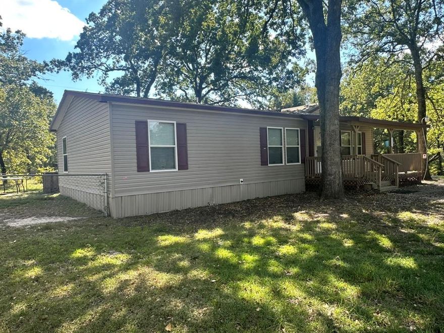 OWNER WILL FINANCE! 10% DOWN, 10% INTEREST. Built in 2014, Open Concept mobile with 3 bedrooms and 2 baths on 3 lots in a quiet neighborhood with mature shade trees and a pool. Small area in back already fenced in for small pets.  Lots of kitchen cabinets with an island open to the living room, and sliding glass doors to the backyard. Split master bedroom with a walk in closet and an additional linen closet in the Master bath.  Master bath also includes double sinks and an extra large shower.  Plenty of storage space in this mobile as well as a storage shed outside. POA offers park, boat dock and fishing pier. Mobile has never been moved, this is it's original location. Renter has moved out and the property is ready to move-in.