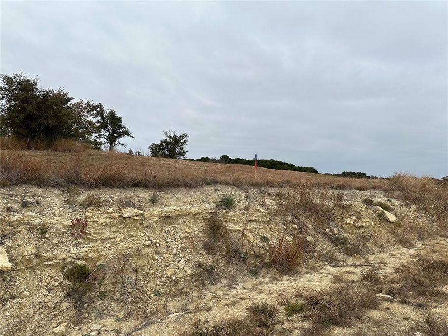 Discover the potential of building your dream home on this beautiful .23 acre undeveloped lot, located in the prestigious gated community of The Retreat in Cleburne, Texas. Nestled amidst rolling hills and scenic views, this lot offers the perfect canvas to design a home that suits your vision, all while enjoying the tranquility of resort-style living.  Residents enjoy exclusive access to world-class amenities, including an 18-hole championship golf course, a resort-style swimming pool, a state-of-the-art fitness center, tennis courts, hiking and biking trails, and a luxurious clubhouse featuring a full-service restaurant and bar.  Situated about 30 minutes from Fort Worth, The Retreat offers the perfect blend of peaceful countryside living and urban convenience. Whether you envision a primary residence or a weekend getaway, this lot provides a rare opportunity to own a piece of paradise in one of Texas’s most sought-after communities. Owner does not have a survey for property, so this will be at the buyers expense to obtain. In order to abide by the Community Covenants and Restrictions there are red and blue stakes to help identify the lot discretely. Please find the CCR, The Retreat building packet, and approved builders attached in the Transaction Desk.