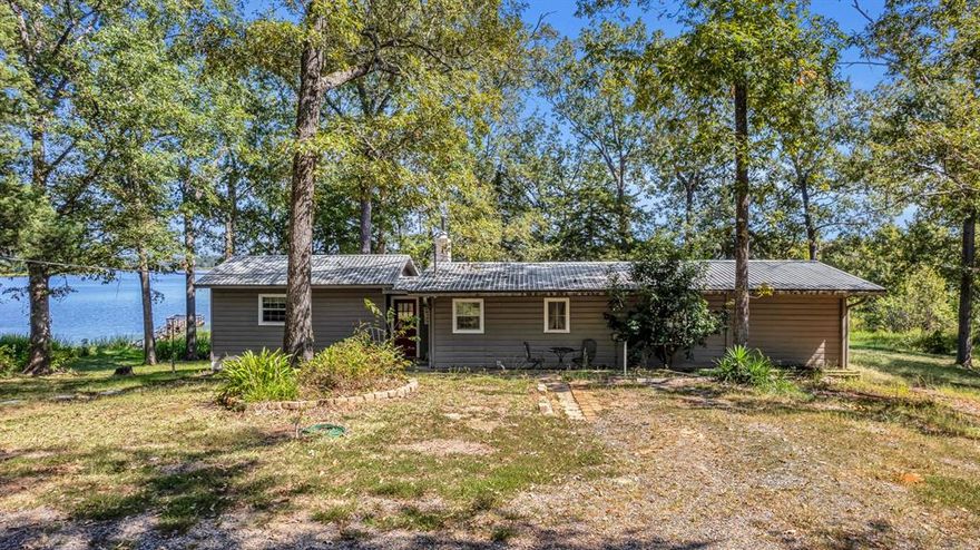 Fully remodeled LAKE HOUSE on Lake Striker!  Welcome home to this fabulous 2 Bed 2 Bath home on Lake Striker on over an acre!  Perfect as your full time home, a vacation home, or even a vacation rental, this gorgeous spot has views to please everyone.  Located on a quiet part of Lake Striker with great privacy from tree cover, this home has plenty of space with a large great room, dining area with shiplap, fully screened back porch, extra large deck, and fishing pier.  Windows line the back of the home, which means you get gorgeous sunrise views from the kitchen and dining areas!  Both bathrooms have been beautifully remodeled, and the laundry area is full-sized.  Spend rainy afternoons on the screened porch, sunny mornings on the full deck, and chilly nights by the fireplace.  A separate workshop houses all of your water toys.  Lake Striker is a wonderful spot for boating, fishing, and canoeing less than an hour from Tyler.  Largemouth bass, spotted bass, catfish, crappie, bluegill, and sunfish are abundant here!  Don't miss this opportunity for lake life living on Lake Striker!  Call today!