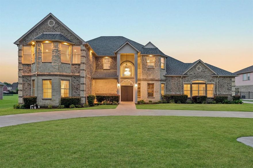 Welcome to a rare blend of luxury, space, and flexibility in the highly sought-after Lake Ridge community! This stunning custom-built 2016 home sits on over an acre in acclaimed Midlothian ISD, offering the perfect balance of elegance and everyday comfort.
From the moment you enter, you’re greeted by impressive ceiling heights, a striking entryway, rich marble floors, and detailed custom craftsmanship that elevate the entire space. The home lives large, with expansive rooms and a seamless flow that feels both open and inviting. The main level offers a highly functional layout with 2 bedrooms, 2.5 baths, and a private study, perfectly suited for multi-generational living or hosting guests in comfort.
Upstairs is designed for both relaxation and versatility, featuring 3 additional bedrooms, an oversized gameroom, dedicated media room, and two flexible bonus spaces ideal for a home gym, creative studio, or additional office setups.
The chef’s kitchen is a true centerpiece, complete with a 6-burner Thermador gas range, pot filler, double ovens, oversized island, and an expansive walk-in pantry, designed for both entertaining and everyday living.
Step outside to your private backyard oasis featuring a sparkling pool, oversized yard, and a screened-in patio, perfect for year-round outdoor entertaining.
A major bonus is the 1,200 sq ft detached back house (not included in main square footage), fully equipped with HVAC and electricity. Whether you envision a pool house, guest quarters, man cave, workshop, gym, or executive office, the possibilities are endless.
Additional highlights include a spacious driveway, ample parking, and convenient access to major highways while still enjoying a peaceful, country-like setting.