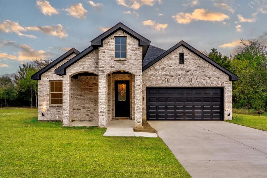 This stunning custom home is situated on a peaceful and large wooded 0.480-acre lot in the heart of Terrell. Featuring 4 bedrooms, 3 full baths, and a flex room. This home has all of the space you're looking for, with all the bells and whistles of today's best options in new construction. This open floor plan welcomes you as soon as you walk in the door with beautiful cathedral ceilings, hand-scraped hardwood flooring, a gas fireplace, Quartz countertops, and a great kitchen to entertain. The master suite has tiled shower, a tub, dual vanity sinks, and a huge walk-in closet. The covered patio is a great place to relax and enjoy our beautiful Texas sunsets. Only minutes from shopping centers, restaurants, and the historic downtown district of Terrell, and no HOA. Come and make this your home just in time for the holidays.