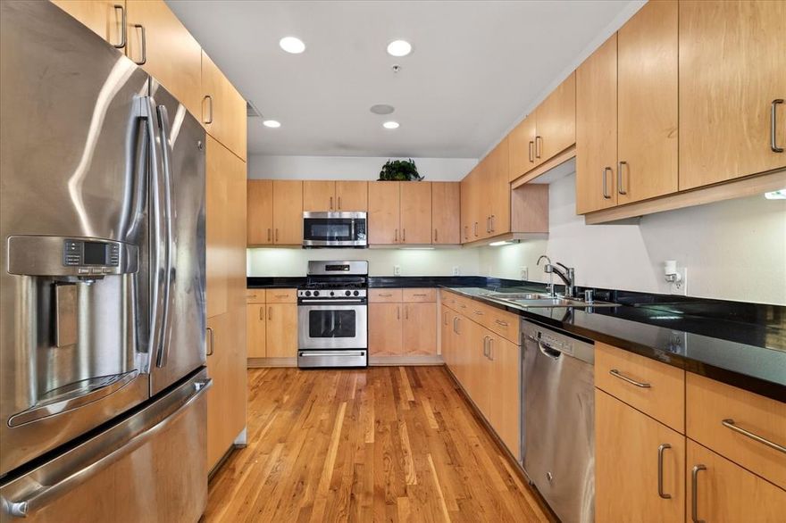 Stunning two-bedroom, 2.5-bath, two-story condo offering luxury living with concierge service and premium finishes throughout. The open-concept main level features granite countertops, stainless steel appliances in the kitchen, with rich wood flooring throughout, perfect for both everyday living and entertaining. Private secondary bedroom on 1st floor with ensuite bath. Spacious primary bedroom upstairs with travertine countertops and matching travertine flooring, creating a spa-like retreat. Thoughtfully designed layout provides privacy, functionality, and modern elegance. Private balcony through the living room and the primary bedroom. Enjoy a lock-and-leave lifestyle with building amenities, secure access, and a prime location close to shopping, dining, and major conveniences. Ideal for professionals, investors, or anyone seeking upscale, low-maintenance living.