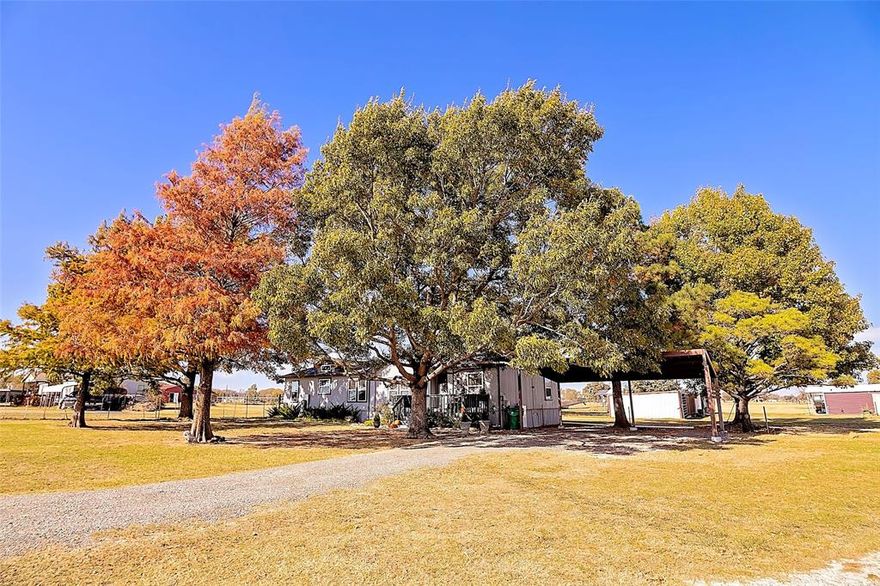 If you’ve been dreaming of peaceful country living with room to grow, this is the one. This fully remodeled 3 bed, 2 bath home sits on 4.72 gorgeous acres outside city limits, offering quiet mornings, wide-open views, and a layout designed for comfort. Inside, you’ll love the clean, modern updates and vinyl flooring throughout. Outside, enjoy relaxing or entertaining on two covered porches overlooking your land. The property is set up for both work and play. A charming pond with a fountain welcomes you home, while three versatile buildings—each equipped with electricity—give you flexibility for hobbies, business, livestock, or guests. The 40x20 building (with 10x10 tack room) is perfect for a future barn setup, the 18x35 equipment barn keeps your tools and machinery organized, and the 34x17 building with concrete slab is ready for a guest suite, workshop, or creative space. Eco-conscious buyers will love the full solar system, Tesla battery backup, and EV charging station, making the property both sustainable and efficient. A 2-car carport and large storage container complete the package. This is more than a home—it’s a lifestyle. Come enjoy the space, freedom, and endless possibilities.