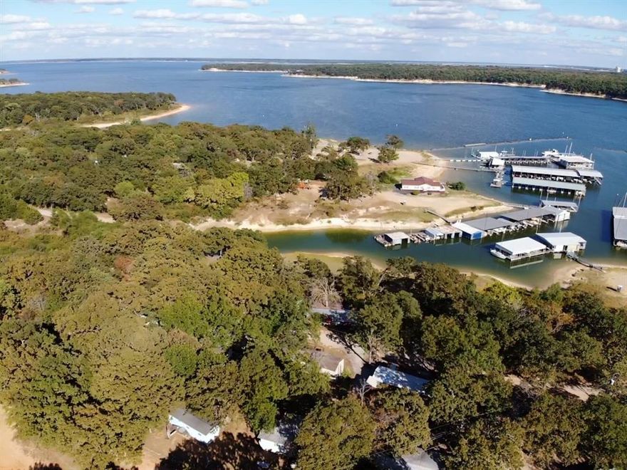 Discover your dream retreat in this charming lake house with stunning views in the Lighthouse Resort and Marina community. This home boasts a lake view and a large screened-in porch, ideal for morning coffee or relaxing sunset views. Located in a vibrant golf cart community with easy access to amenities and the acclaimed Pottsboro School District, this property offers a perfect lakeside lifestyle. Don’t miss out!