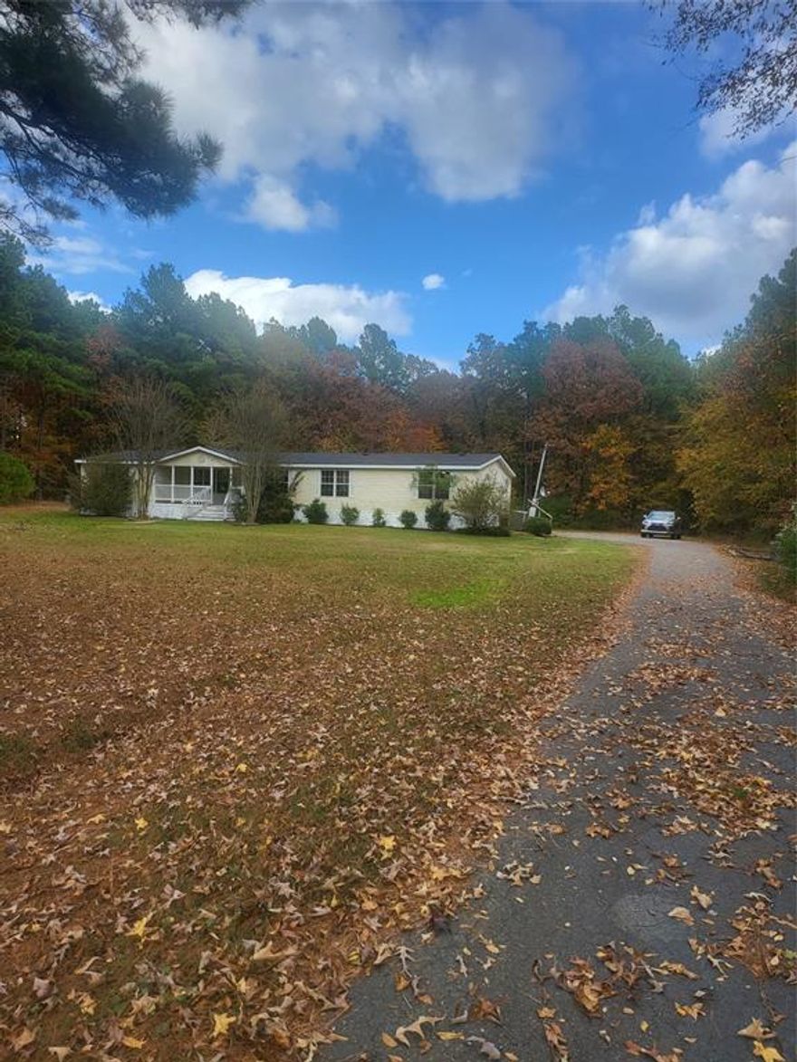 This charming 4-bedroom, 2-bath manufactured home sits on 5 beautiful acres, offering a perfect blend of open space and wooded privacy. Recently remodeled, the home features brand-new flooring throughout, giving it a fresh and modern feel.

The spacious living area flows seamlessly into a bright kitchen, ideal for family gatherings or entertaining guests. Each bedroom offers comfortable space and natural light, while the primary suite includes a private bath for added convenience.

Outside, the property provides plenty of room for outdoor activities, gardening, or simply enjoying the peaceful surroundings. With a mix of open land and mature trees, this home offers both tranquility and versatility — a perfect country retreat in the middle of the city with modern updates.