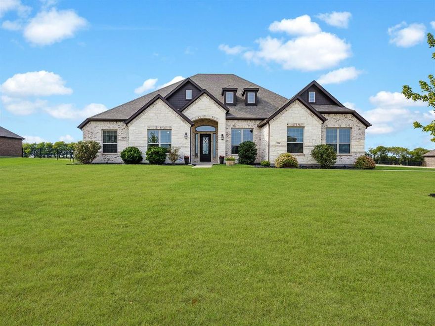 Discover luxury and comfort in this nearly new, sprawling single-story home, nestled on a peaceful 1.5-acre lot with a 3 car garage, in the highly desirable community of Heath, located within acclaimed Rockwall ISD. A striking iron front door welcomes you into a thoughtfully designed layout where style meets functionality. Rich hardwood floors guide you through an expansive light-filled open concept floorplan ideal for everyday living and effortless entertaining. At the heart of the home, the upgraded kitchen is equipped with Frigidaire Gallery stainless steel appliances, a 5-burner gas cooktop, granite counter-tops, oversized island with farm sink, and spacious walk-in pantry. The adjacent dining room allows plenty of room for the entire family to enjoy meals, and perfect for hosting gatherings. The private primary suite is separated from the secondary bedrooms for enhanced privacy, with a spa-like ensuite bath featuring dual vanities, soaking tub, oversized walk-in shower, and a Texas-sized walk-in closet. Each secondary bedroom includes an ensuite bath, providing comfort and convenience for family or guests. Movie nights and game days are a hit for adults and kids in the dedicated media room, offering a perfect space for family fun and relaxation. Step outside to your expansive covered and open patio overlooking the backyard of your dreams where you'll fall in love with beautiful Texas sunset skies. With 1.5 Acres fully fenced, you have plenty of room to add a pool, outdoor kitchen, or entertainment space, your backyard can become the ultimate outdoor oasis, the possibilities are endless. Don’t miss the opportunity to own this exceptional home that perfectly balances peaceful country living with modern elegance. NO MUD. NO PID.