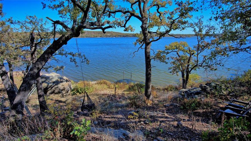 Nestled along Scenic Hill Drive, this 1.17-acre waterfront property offers sweeping views of Lake Amon G. Carter and a stunning landscape filled with mature oak trees. The land gently slopes from the gated entrance at its highest point down to the water’s edge, providing direct lake access and an ideal setting for future home or cabin plans. Already equipped with an electrical pole, meter, and RV hookup near the entrance, it’s perfectly suited for immediate enjoyment as a weekend retreat—bring your RV, set up camp, and start relaxing. With coveted lake frontage and endless opportunities for fishing, boating, water skiing, canoeing, and more, this tract combines natural beauty with exceptional recreational potential, making it a rare and inviting escape.