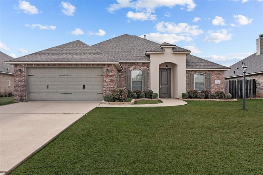 Welcome to 345 North Hampton in Tuscany Crossing, an immaculate and meticulously maintained home that truly feels better than new in the highly sought-after Haughton School District. Built in 2018 and offering nearly 2,000 square feet of thoughtfully designed living space, this home stands out for its exceptional condition, beautiful finishes, and peaceful backyard setting. Homes this clean and well cared for rarely come available, and buyers will immediately notice the pride of ownership throughout.

Step inside and you’ll find an inviting open floor plan filled with natural light from large cased windows. The living room welcomes you with tray ceilings, crown molding, a gas-start fireplace, and custom built-in shelving that create a warm and elegant focal point.

The gorgeous white kitchen features granite countertops, stainless appliances, upgraded backsplash, abundant cabinetry, and a functional island that flows seamlessly into the dining and living areas, making it perfect for everyday living and entertaining.

The primary suite offers a relaxing retreat with double vanities, a spacious walk-in closet, and a spa-style bathroom with a soaking tub and separate tiled shower.

Step outside to enjoy your own private backyard oasis. The covered patio overlooks beautifully maintained landscaping with blooming azaleas, manicured garden beds, and a professionally installed French drain system designed to keep the yard looking its best.

Additional highlights include crown molding throughout, window blinds, decorative garage door, and a fully fenced backyard.

Conveniently located just minutes from I-20, Barksdale Air Force Base, schools, dining, and shopping, this home offers the perfect combination of comfort, convenience, and community living.

Qualifies for Rural Development financing with zero money down.

Schedule your private showing today.