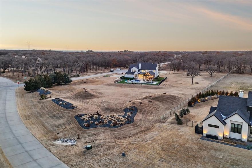 Located in prestigious Hat Creek Estates, this fully renovated Bartonville estate offers a rare blend of privacy, design, and resort-style living on 2.85 beautifully landscaped acres with rolling berms and mature trees. Extensive, high-quality updates throughout deliver a level of finish and functionality rarely found in Argyle ISD.

A welcoming front porch leads to dramatic double iron-and-glass entry doors and an interior where every detail has been intentionally curated. Highlights include a floating staircase, linear gas fireplace, custom designer lighting, and a light-filled open-concept layout ideal for both everyday living and entertaining. The chef’s kitchen anchors the home with premium appliances, including a built-in Miele coffee system and steam oven, along with an expansive walk-in working pantry that balances form and function.

Outdoor living is equally impressive. A custom Claffey heated diving pool and spa are framed by extended patios, lighted decks, built-in heaters, and a firepit, creating a true private retreat. Artificial turf surrounds the pool area and extends to a dedicated dog run. Entertaining is elevated with a built-in Yoder smoker and Evo flat-top grill, complemented by a whole-home audio system that flows seamlessly indoors and out. Lush professional landscaping is sustained by a full-property irrigation system supplied by a private well.

Additional features include a private Par-3 golf hole, 50-amp RV plug, secondary upstairs laundry, and extensive whole-home audio. While the property is part of the Hat Creek Estates HOA, it predates the association and is grandfathered from current architectural and construction restrictions, providing exceptional flexibility for future improvements such as an ADU or guest residence (buyer to verify). Located within Argyle ISD and benefiting from comparatively low tax rates, this move-in-ready estate presents a rare opportunity in one of Bartonville’s most sought-after communities.