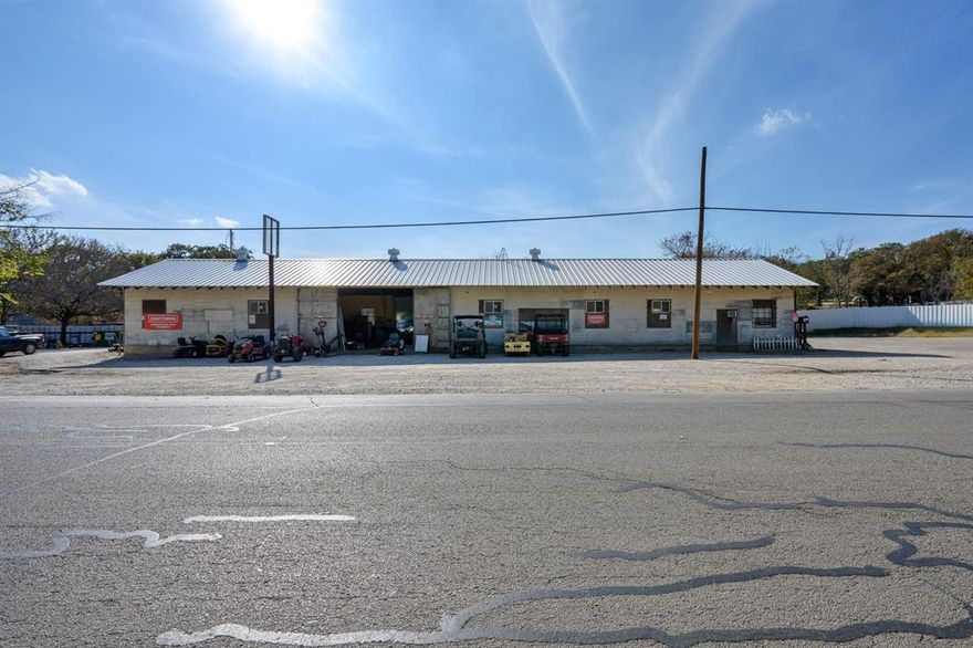 Great opportunity to own an existing business or to purchase just the building and improvements on a prime piece of real estate in Mineral Wells. This 2,875-square-foot industrial shop, situated on just under an acre, is currently home to a locally owned, well-established, and thriving small engine service specializing in lawn mower repair.
The shop features roll-up entrances on two sides, a large central work and machinery area, office and flex spaces including storage areas, and a restroom. The property offers ample customer parking, a large area for client inventory, and additional cross-fenced sections with potential for other commercial uses or future expansion.
The listed price is for the property and improvements only. Sales price including both the property and the business is $580,000. Schedule a private tour today!