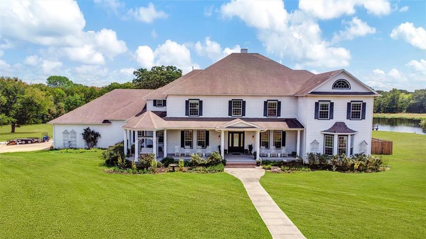 Stately, private & grand country home! Enter the gate & drive through mature trees & acreage to the sprawling estate-style layout & beautifully designed porch stretching across the front w plenty of cozy seating. Huge 2 story home, featuring 10 bdrms+10 baths. Enter the foyer to sweeping staircase w oversized combined living room w fireplace, that flows to the large kitchen+pantry. Leading outside to take in the gorgeous TX sunsets from the XL back porch that overlooks the sparkling pool & adjacent pond. Master suite down that includes vaulted ceiling, siting area, separate vanities and big walk-in closet. Upstairs features an open sitting area, 6 bedrooms; 3 oversized & spacious dorm-like bdrms, perfect for retreats or hosting large groups, extra office or movie room, all carpeted & each w its own separate bath. Well maintained home designed w comfort in mind & offers plenty of storage, 4 car garage w an endless amount of parking and play space, all surrounded by an amazing 123 acres.